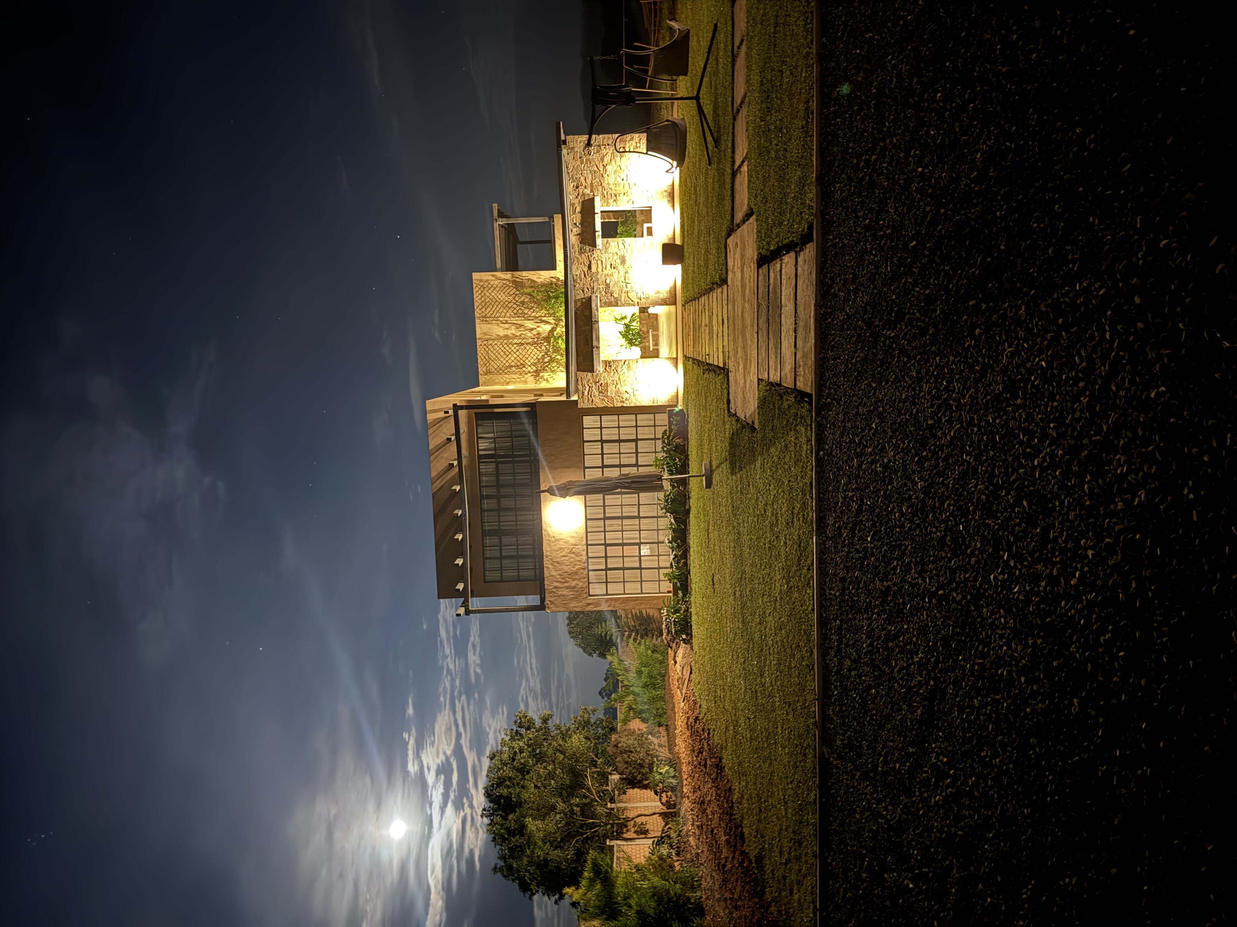 Panoramic view of Kokasemera Country Villa outdoor living space with Rwenzori mountains in the background